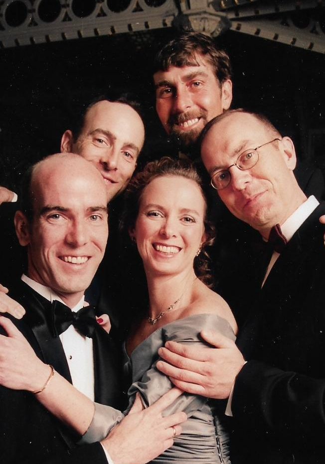 A photo of he Dempsey siblings, five adults in formal clothes.